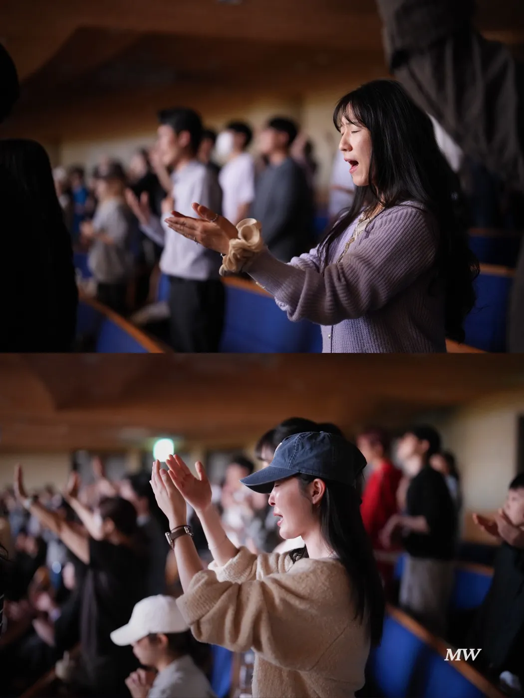 Worshipers in the seats raising their hands in praise