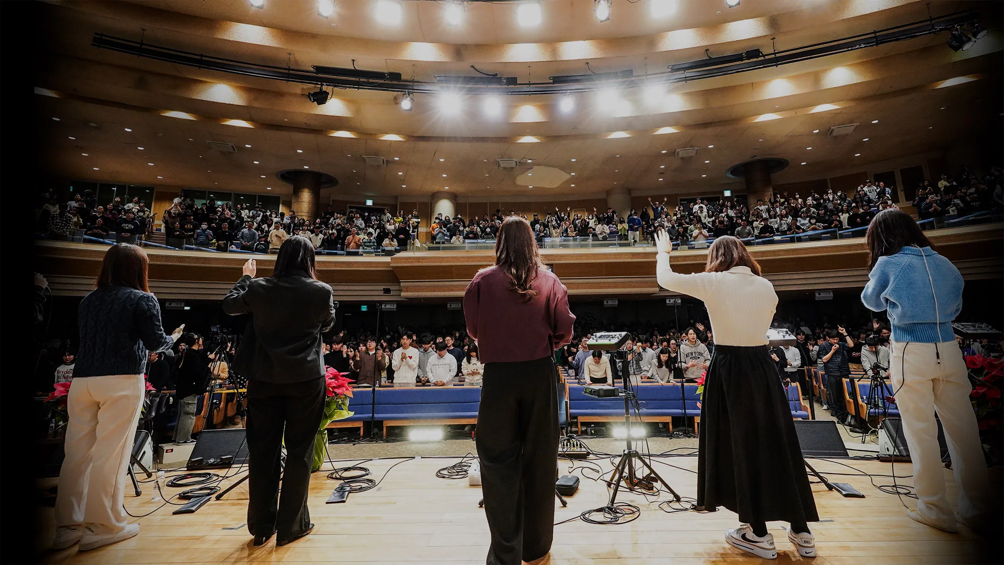 An invited worship event. Markers Worship leads praise as the congregation raises their hands and sings.