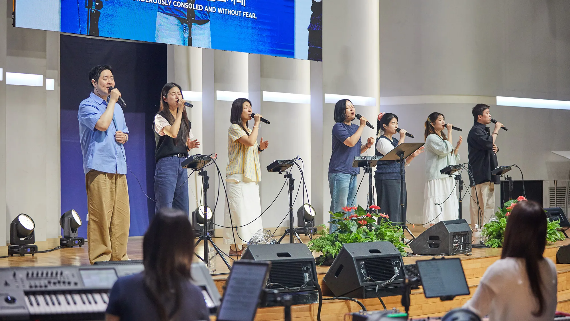 Thursday Worship. Young people stand and sing praise together.